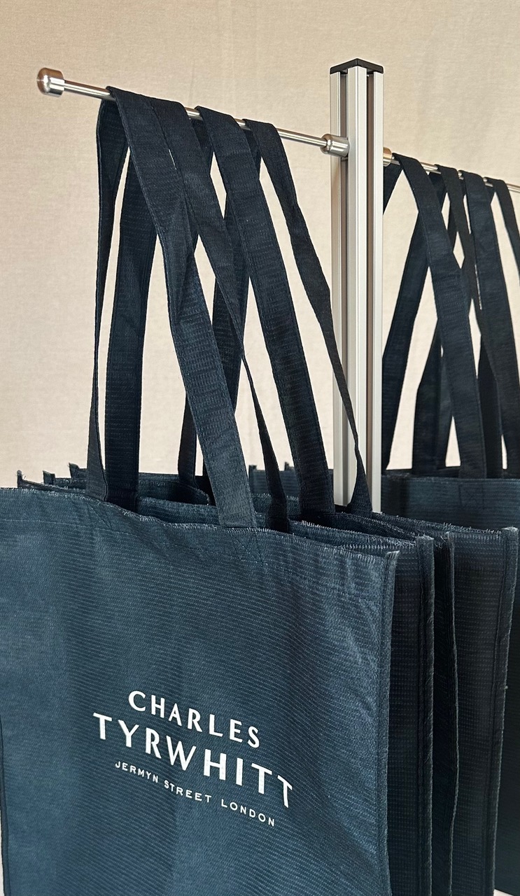Close-up of Charles Tyrwhitt bags hanging on hooks