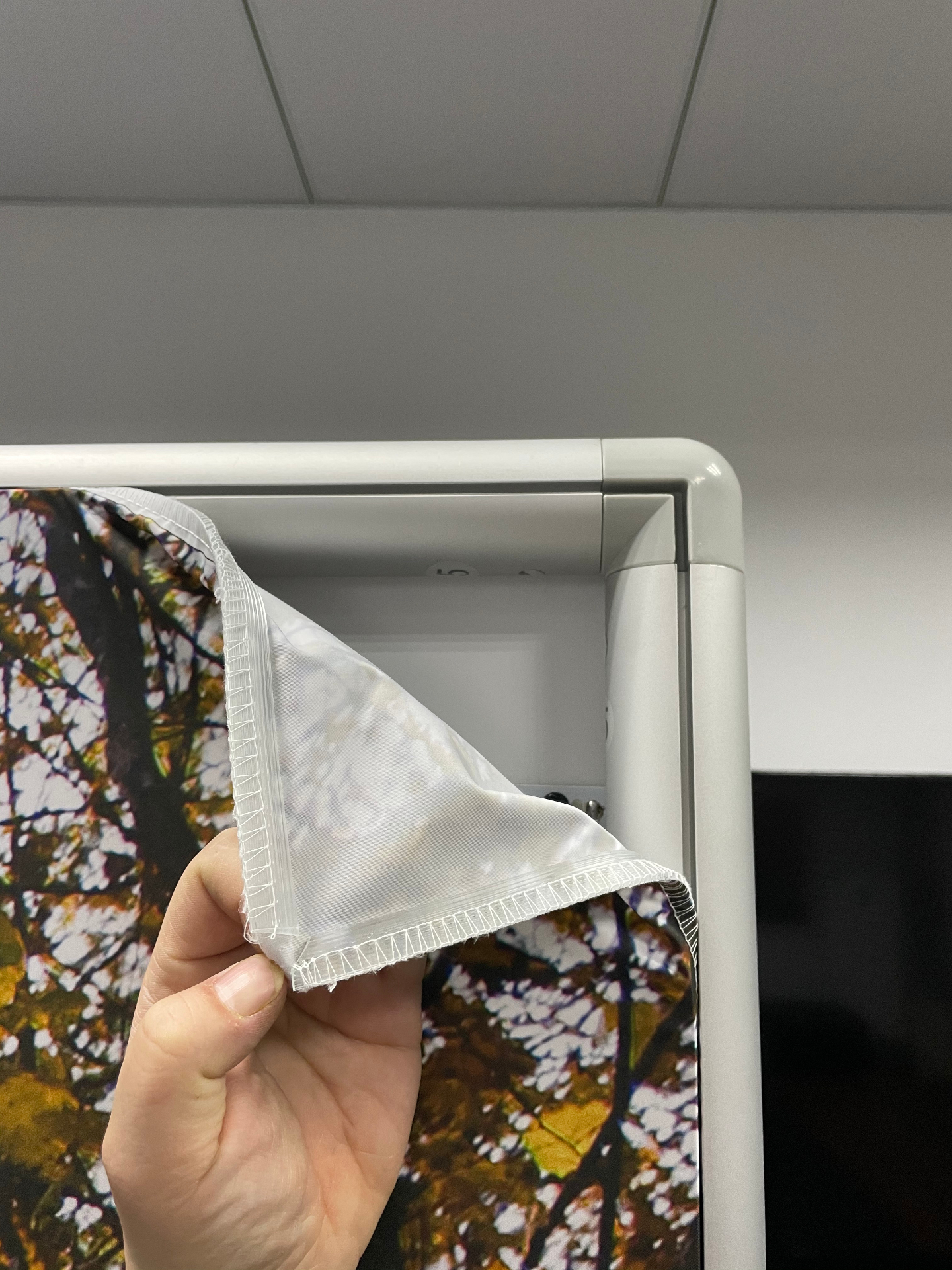SEG silicone edge graphic being inserted into the frame channel
